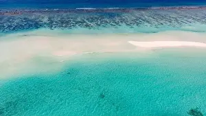 Aerial photo of beautiful paradise Maldives tropical beach on island. Coral reef around atolls, amazing nature. Summer and travel vacation concept