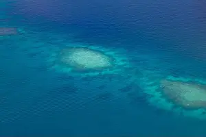 Aerial photo of beautiful paradise Maldives tropical lagoon with coral reef beach on island. Summer and travel vacation concept.View from seaplane