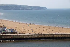 Aerial photo of the beautiful town of Whitby in the UK in North Yorkshire in the UK showing people on the sandy beach