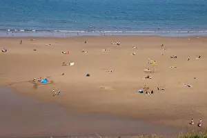 Whitby Prints: Aerial photo of the beautiful town of Whitby in the UK in North Yorkshire in the UK showing people on the sandy beach