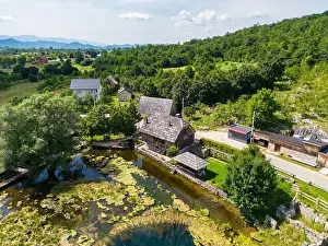Aerial photo of Majerovo Vrilo, set of wooden mill houses on the source of Gacka river in the village of Sinac, Croatia