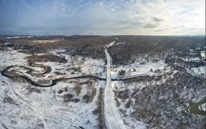 Aerial photo panorama of Koen river and road bridge under ice and snow. Beautiful winter landscape