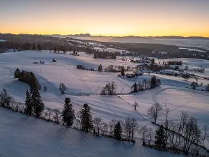 Lonesome Prints: Aerial photo of snowy landscape in moody sunset twilight in the Allgaeu mountains next to Oberreute in Bavaria