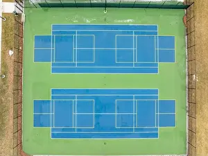 Extended Prints: Aerial photo of unusually painted outdoor blue tennis courts with yellow pickleball lines and green out of bounds area