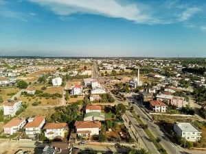Senegal Prints: Aerial photograph of a town at sunset. A town with two-storey detached houses and a mosque
