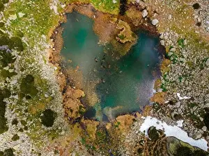 Aerial photography of a colourfull mountain glaciar lake located in Retezat National Park