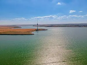 Midday Prints: Aerial photography over Techirghiol lake with a patch of land and the radio TV relay on it at Eforie
