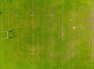 Turf Prints: An aerial shot captured by a drone showcasing a detailed perspective of a lush green sports field