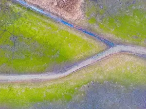 Dron Prints: An aerial shot of the landscape with small lake surrounded by trees and field