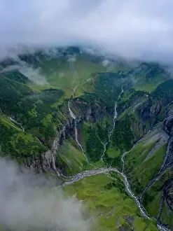 Aerial shot of several large waterfalls cascading down a steep cliff