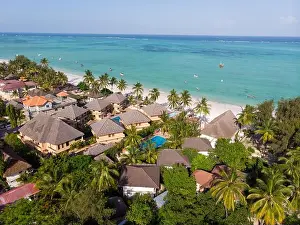 Zanzibar Prints: Aerial shot of a luxury hotel on a Beach first line with Palm Trees Garden at evening time in Paje village