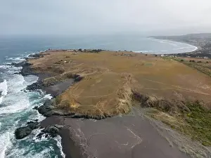 Surfers Prints: Aerial shot of the pacific ocean, beach and the bay La Pancora at Pichilemu, Chile