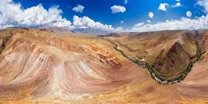 Called Prints: Aerial shot of the textured yellow nad red mountains resembling the surface of Mars