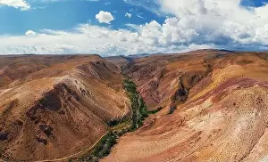 Summer Mountain Prints: Aerial shot of the textured yellow nad red mountains resembling the surface of Mars