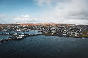 Explore Denmark Prints: Aerial shot of the town Torshavn and its harbour as taken during a helicopter flight on an early spring morning