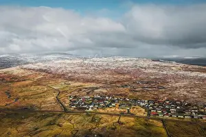 Explore Denmark Prints: Aerial shot of the town Torshavn as taken during a helicopter flight on an early spring morning with snow-covered