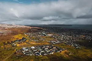 Explore Denmark Prints: Aerial shot of the town Torshavn as taken during a helicopter flight on an early spring morning with snow-covered