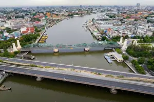 Aerial shots taken from a drone of Phra Pok Klao Bridge and Phra Phuttha Yot Fa Bridge. crossing the Chao Phraya River in the morning with temple