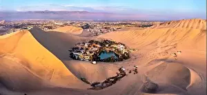 Aerial sunset view of the Huacachina Oasis in the Atacama desert of Peru