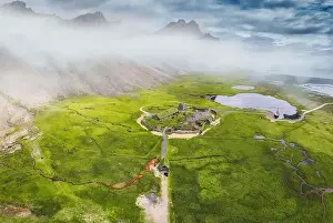 Aerial view of abandoned icelandic viking village on wilderness near Vestrahorn mountain during summer at Stokksnes