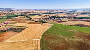 Land Lot Prints: Aerial view of agricultural fields and rural town in the background. Segovia
