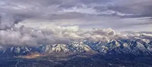 Sunset Mountain Prints: Aerial view from airplane of the Wasatch Front Rocky Mountain Range with snow capped peaks in winter including urban