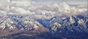 Sunset Mountain Prints: Aerial view from airplane of the Wasatch Front Rocky Mountain Range with snow capped peaks in winter including urban
