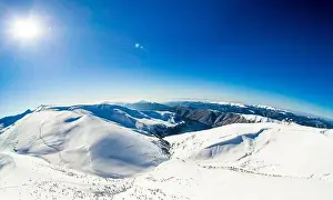 Mountain White Prints: Aerial view of an amazing mesmerizing view of a mountain winter landscape on a sunny frosty day at a ski resort