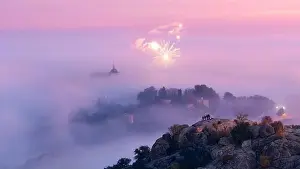 Alcazar Prints: Aerial view of ancient town and medieval Alcazar de Toledo palace in mist in colorful daybreak