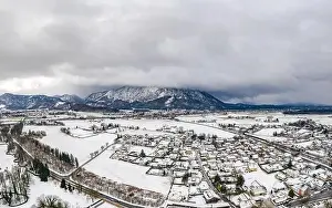 Untersberg Prints: Aerial view of Austrian Alps valley village near Untersberg mountain and Salzburg outskirts in winter during heavy snow