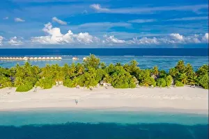 Aerial view of beach in Maldives. Amazing aerial landscape in Maldives islands, blue sea and coral reef view from drone or plane. Exotic summer travel