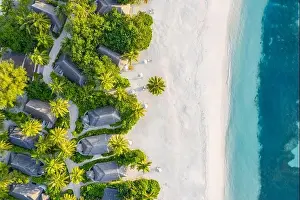 Aerial view of beach in Maldives. Amazing aerial landscape in Maldives islands, blue sea and coral reef view from drone or plane. Exotic summer travel