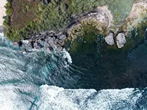 Aerial view of beautiful blue sea waves breaking on sandy coastline