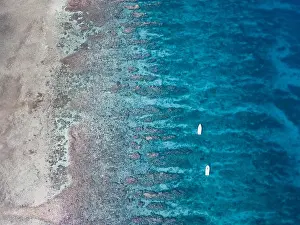 An aerial view of a beautiful coral reef on the edge of Turneffe Atoll off the coast of Belize. This area of the Caribbean is extremely biodiverse