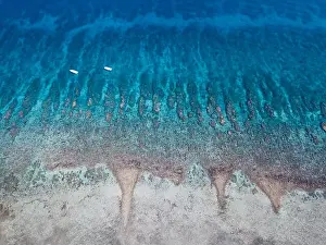 An aerial view of a beautiful coral reef on the edge of Turneffe Atoll off the coast of Belize. This area of the Caribbean is extremely biodiverse