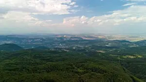 Aerial view of beautiful green forest covering the mountain range