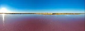 Pink Lake Prints: Aerial view of the beautiful pink lake and salt production of the Camargue in front of the village of Aigues Mortes