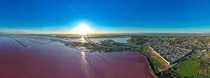 Pink Lake Prints: Aerial view of the beautiful pink lake and salt production of the Camargue in front of the village of Aigues Mortes