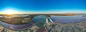 Pink Lake Prints: Aerial view of the beautiful pink lake and salt production of the Camargue in front of the village of Aigues Mortes