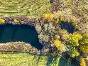 Aerial Shot Prints: Aerial view of beautiful smooth green waters of a lake on a sunny autumn day