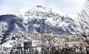 Aerial view of the beautiful snow-covered village of Opi with snow-capped mountains in the background