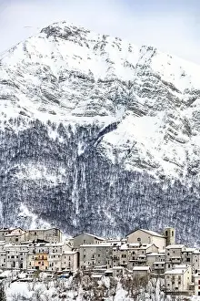 Comune Prints: Aerial view of the beautiful snow-covered village of Opi with snow-capped mountains in the background