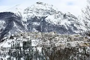 Comune Prints: Aerial view of the beautiful snow-covered village of Opi with snow-capped mountains in the background