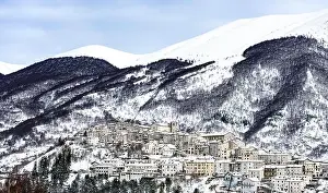Comune Prints: Aerial view of the beautiful snow-covered village of Opi with snow-capped mountains in the background