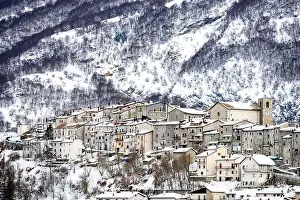 Comune Prints: Aerial view of the beautiful snow-covered village of Opi with snow-capped mountains in the background