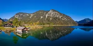 Boathouse Prints: aerial view to boathouse at lake plansee in fall mood with great reflections in clear blue water