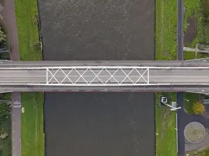 Water Transportation Prints: Aerial view of a bridge over a river with a water way river running underneath