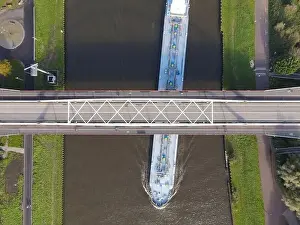 Water Transportation Prints: Aerial view of a bridge over a river with a water way river running underneath