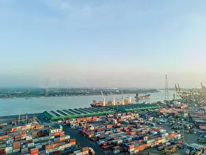 Industrial Port Prints: Aerial View of Busy Container Port and Cargo Ships on River - Industrial Shipping and Global Trade Scene