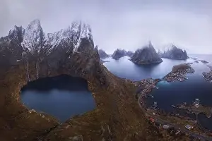 Inhabited Prints: Aerial view of calm water of sea washing island with rocky formations under cloudy sky